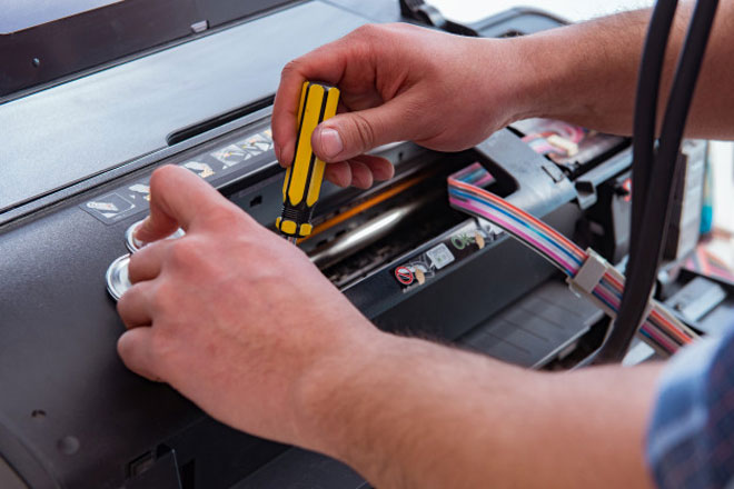 Man fixing a broken printer
