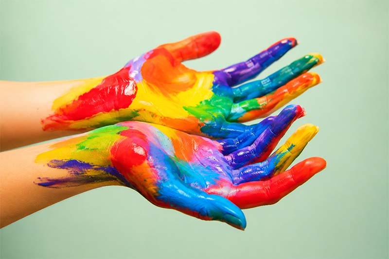 Colorful painted hands in a studio setting