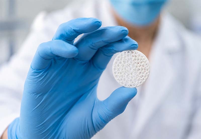Laboratory technician handling porous disc Laboratory technician handling porous disc