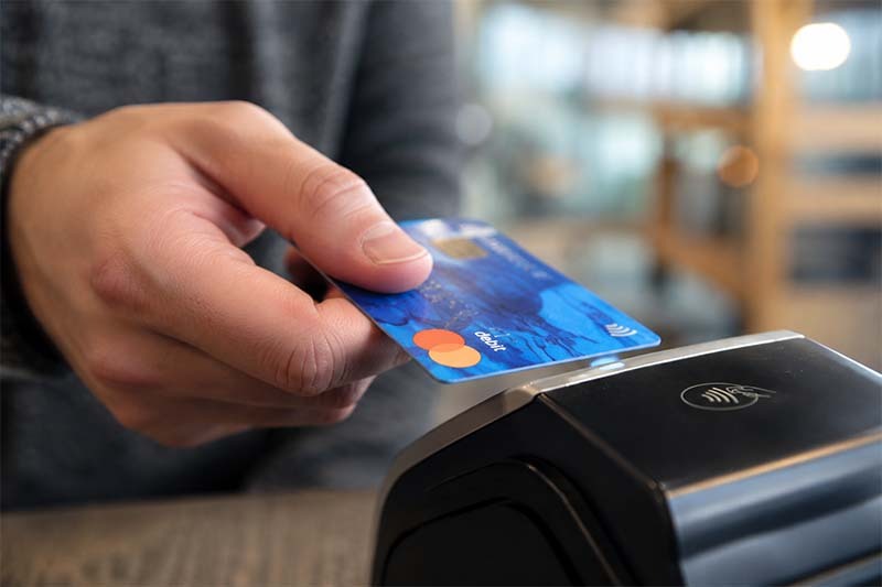 Man using a debit card Man using a debit card
