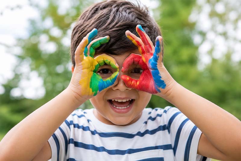 Playful child with painted hands Playful child with painted hands