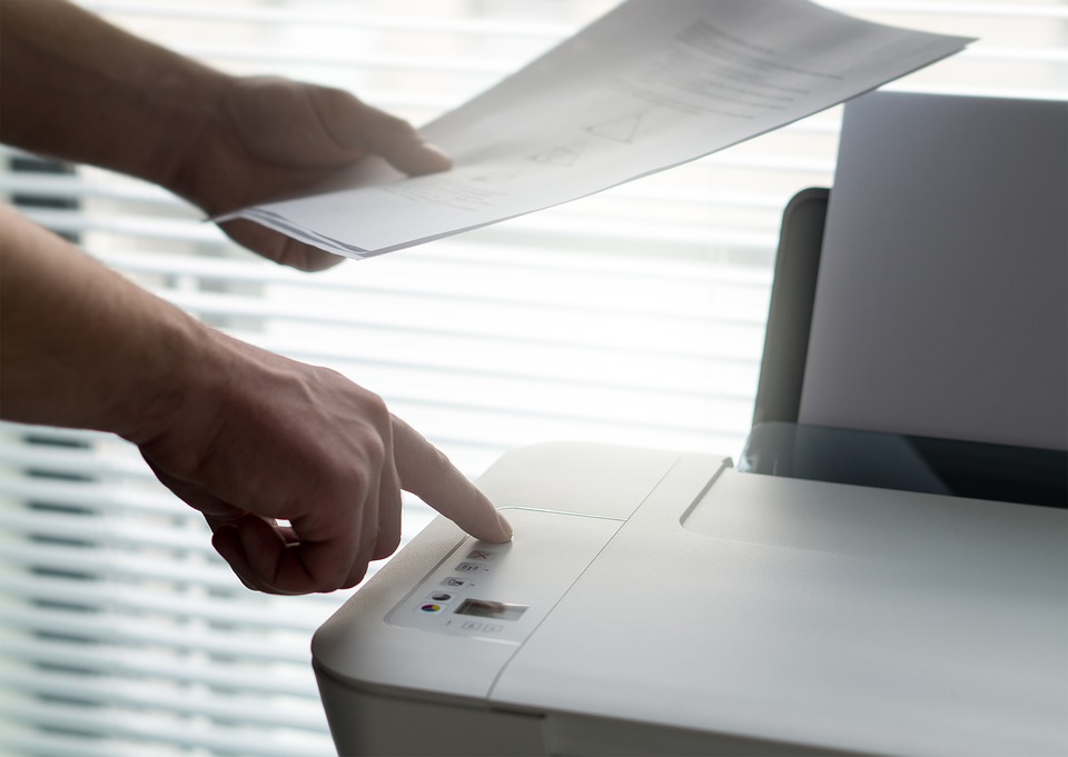 person using an inkjet printer at work