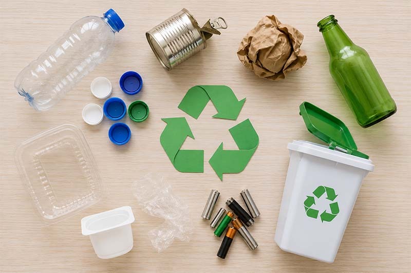 Recycling essentials on woodgrain surface Recycling essentials on woodgrain surface