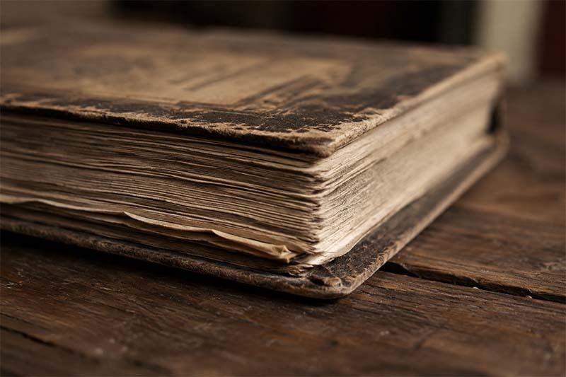 Worn pages on a rustic table